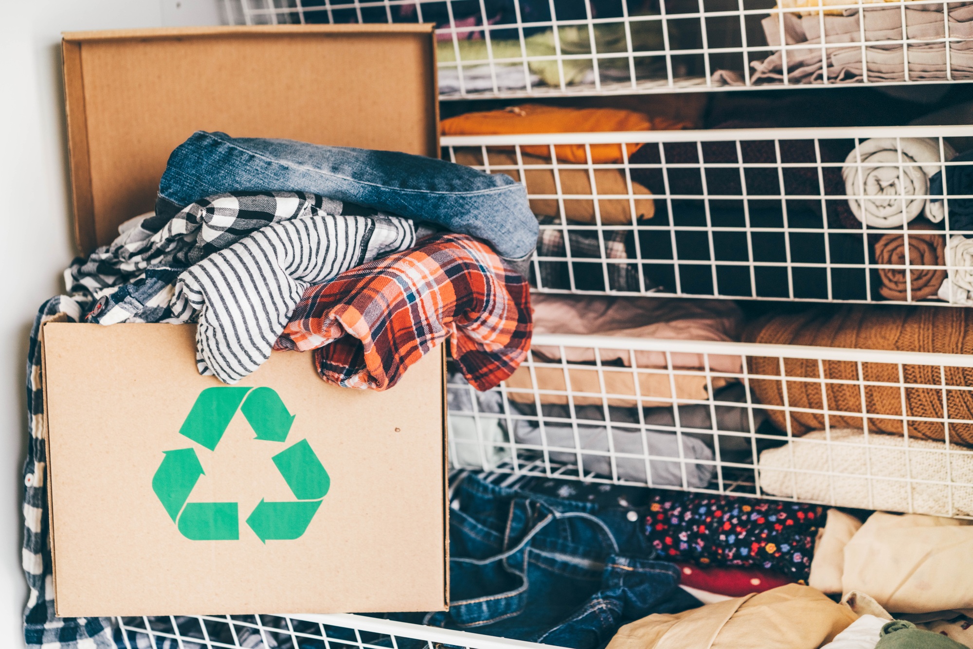 Recycle clothes concept. Recycling box full of clothes.